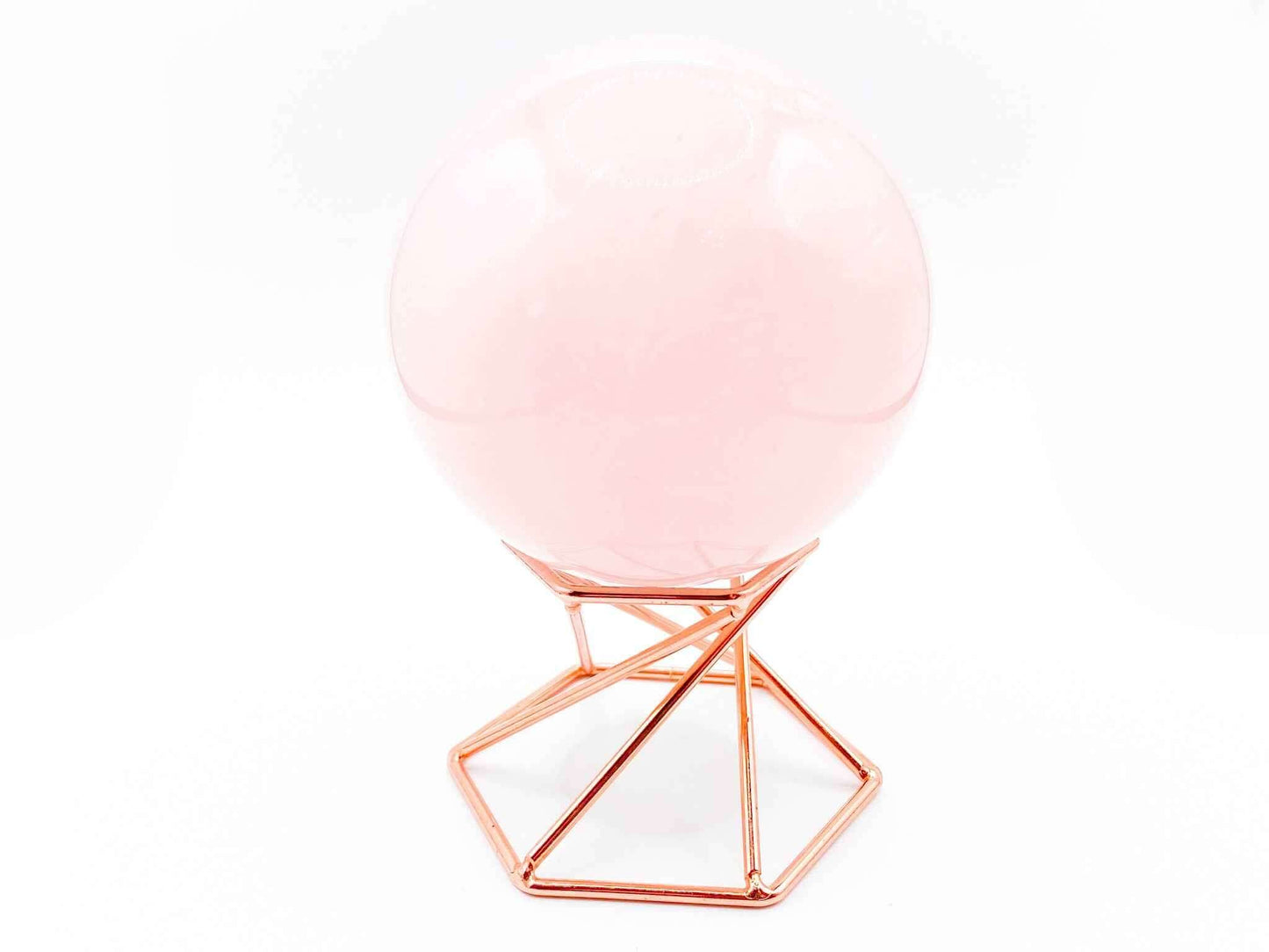 Geometric Crystal Sphere Stand holding a large pink crystal sphere in a rose gold geometric design.
